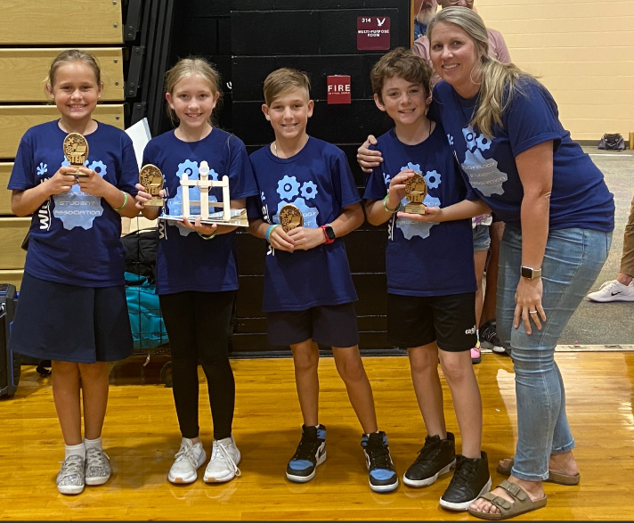 A group of kids holding medalsDescription automatically generated